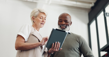 Image showing Business team, tablet and talking while planning strategy together in a office while online for marketing, inspiration and idea for project. Woman and black man with technology for collaboration