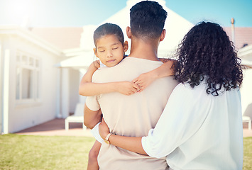 Image showing Young family, back and outdoor at new home with girl child, hug or together for love, beginning and start to life. Couple, mother and daughter with man holding kid for real estate, house and backyard