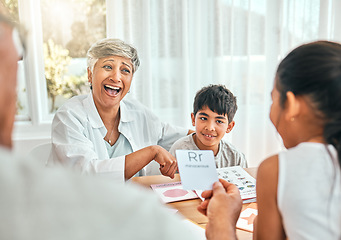 Image showing Education, cards and grandparents with children and letter lesson for language, study and alphabet. School, homework and help with family at table and teaching for language, literacy and phonics