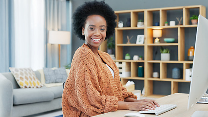 Image showing Portrait of an African American woman using a desktop while doing freelance work from a home office. Successful female entrepreneur researching new ideas and marketing strategies for startup company