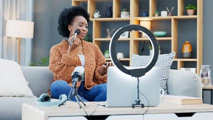 Image showing A female influencer recording a makeup tutorial for her beauty blog or live streaming channel at home. Young woman creating content and engaging with her viewers and subscribers during an online vlog