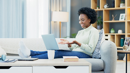 Image showing Happy black woman waving while using a laptop to make a video call in the living room. Young african american female excited to have a casual chat with friends or family at home during lockdown