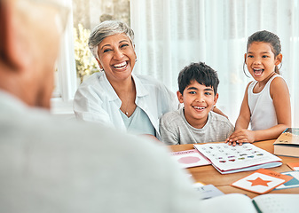 Image showing Happy, homework and grandmother sitting with her grandchildren helping them with fun activities. Happiness, smile and elderly woman spending time and bonding with kids outdoor of the family home.
