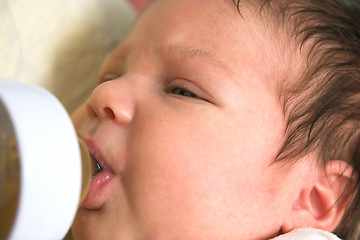 Image showing baby drinking from nursing bottle