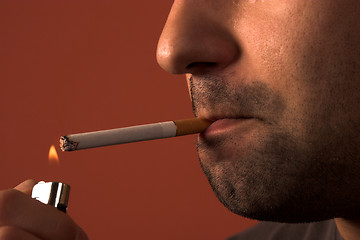 Image showing man lighting a cigarette