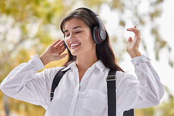 Image showing Music, college and happy with woman in park for streaming, education and online radio. Learning, study and technology with student listening to headphones on campus for university, freedom and relax