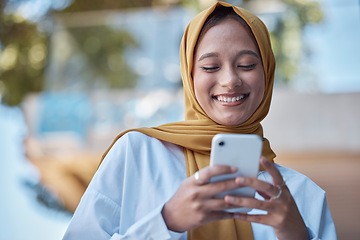 Image showing Phone, outdoor and happy muslim woman on international network, 5g communication and mobile app chat. Young hijab entrepreneur or islamic person from Saudi Arabia typing on cellphone for opportunity