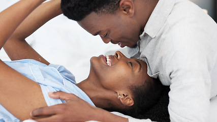 Image showing Black man and black woman couple kiss. Young, in love and African American people in relationship saying I love you. Kissing, romantic and smiling face to face in bed together at home, intimacy