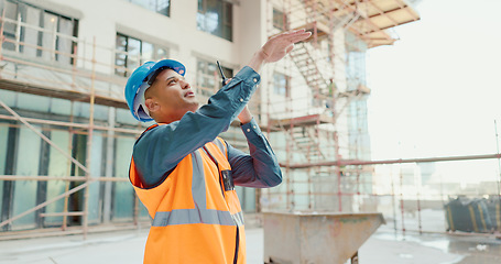 Image showing Construction worker, radio communication and building contractor with team leadership for skyscraper architecture project. Industrial engineer, professional builder and engineering construction site