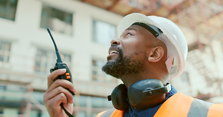 Image showing Construction site, black man and building manager with walkie talkie for logistics, development and update. Project management, communication and construction employee speaking with portable radio.