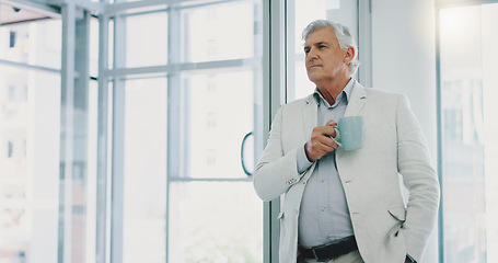 Image showing Successful businessman looking out window having, thinking and having a cup of morning coffee.