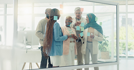 Image showing Business people, planning with glass board and collaboration with postit notes for brainstorming, communication and ideas. Vision, diversity and teamwork with Muslim woman writing, strategy and goals