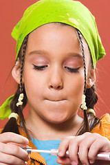 Image showing child applying make-up