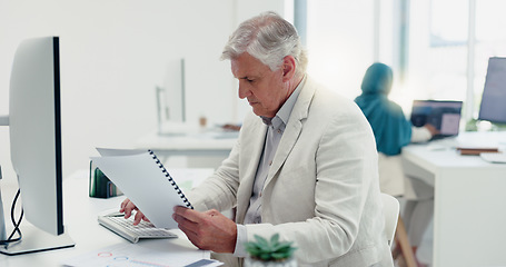 Image showing Business man, computer and documents while working in a office for data analysis while typing online doing research. Senior entrepreneur at his desk with a file for information on a finance report