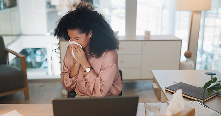 Image showing Black woman, covid and sinus in office with sneeze, tissue and runny nose while working on laptop. Business woman, allergies and unwell corporate employee sneezing and suffering flu, cold and allergy