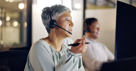 Image showing Senior call center employee, woman and phone call, CRM and face, contact us and talking with client and pen. Customer service, telemarketing or tech support, communication and consultant with headset