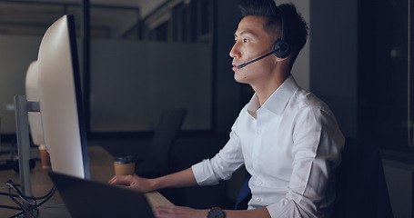 Image showing Call center, consultant and man, CRM and contact us with phone call and communication, pc screen and headset. Telemarketing, customer service or tech support, talk to client and Asian agent help desk