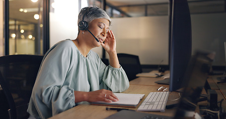 Image showing Night, call center or senior woman tired, exhausted or burnout in workplace, overworked or stress. Dark, female employee or consultant with headset, late night or customer service agent with headache