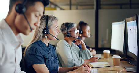 Image showing Senior call center consultant, woman and contact us, CRM and talking in customer service, computer at desk. Phone call, telemarketing and diversity, writing in notebook in coworking space and headset