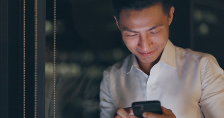 Image showing Smartphone, night and business man networking on global app, happy notification or social media chat. Smile of corporate, asian worker using phone or cellphone in dark office on digital communication