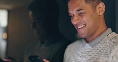 Image showing Face, phone and dark with a business man laughing in an office, working late at night on a deadline. Mockup, contact and good news with a male employee typing a text message at work during overtime