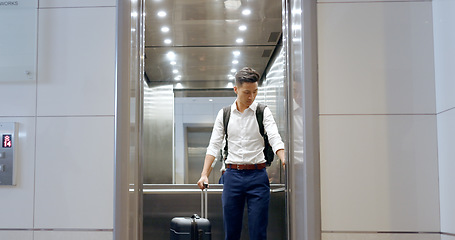 Image showing Elevator, travel and watch with a business asian man in an airport, checking the time of his flight for departure. Door, floor and late with a male employee holding suitcase luggage while traveling
