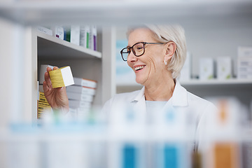 Image showing Pharmacy, pharmacist and senior woman with medicine, pills or box in drugstore. Healthcare, wellness or happy medical doctor laughing and reading label on medication or drugs, vitamins or supplements