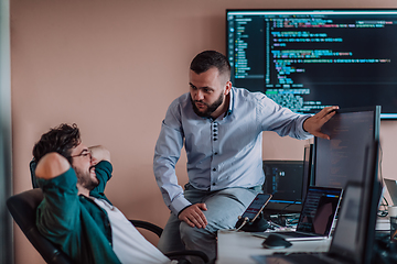 Image showing Programmers engrossed in deep collaboration, diligently working together to solve complex problems and develop innovative mobile applications with seamless functionality.