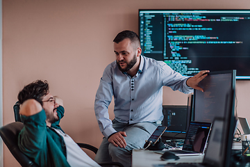 Image showing Programmers engrossed in deep collaboration, diligently working together to solve complex problems and develop innovative mobile applications with seamless functionality.