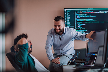 Image showing Programmers engrossed in deep collaboration, diligently working together to solve complex problems and develop innovative mobile applications with seamless functionality.