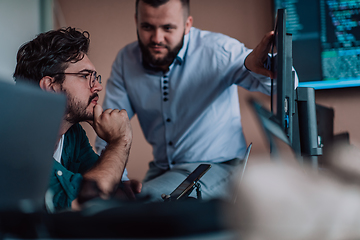 Image showing Programmers engrossed in deep collaboration, diligently working together to solve complex problems and develop innovative mobile applications with seamless functionality.