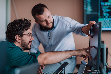 Image showing Programmers engrossed in deep collaboration, diligently working together to solve complex problems and develop innovative mobile applications with seamless functionality.