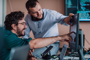 Image showing Programmers engrossed in deep collaboration, diligently working together to solve complex problems and develop innovative mobile applications with seamless functionality.