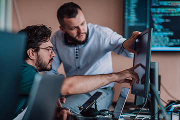 Image showing Programmers engrossed in deep collaboration, diligently working together to solve complex problems and develop innovative mobile applications with seamless functionality.