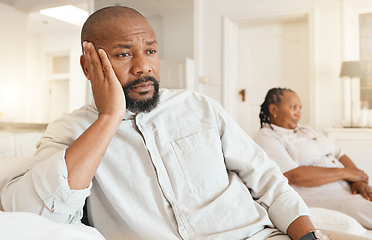 Image showing Stress, depression and divorce of black man on sofa in home living room thinking after fight. Argument, sad and male with anxiety after marriage conflict, cheating or break up, disagreement or affair