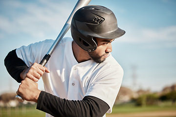 Image showing Baseball, bat and serious with a sports man outdoor, playing a competitive game during summer. Fitness, health and exercise with a male athlete or player training on a field for sport or recreation