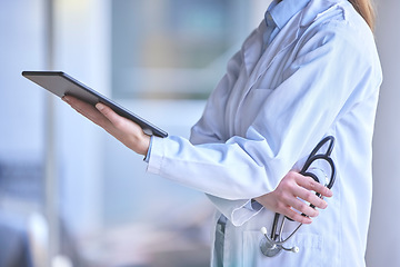 Image showing Digital tablet, healthcare and doctor in the hospital analyzing test results or doing research. Technology, stethoscope and professional female medical worker reading information on a mobile device.