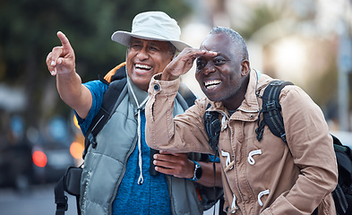 Image showing Travel, city tourism and men pointing on walk, explore vacation or tourist adventure in retirement. Happy friends, sightseeing search and smile on outdoor journey, direction or fun holiday experience