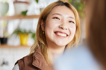 Image showing Face, happy or smile and an asian woman in a coffee shop, enjoying spending time with a friend. Cafe, brunch and lifestyle with an attractive young girl sitting in a restaurant for a chat or catch up