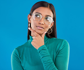 Image showing Mockup, Indian woman and thinking with decision, future and fantasy with girl against a blue studio background. Female, lady and imagination with opportunity, choice and ideas with wonder and eyewear