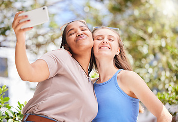 Image showing Selfie, friendship and women on an outdoor walk for wellness, health and exercise in the park. Love, smile and happy interracial female best friends taking a picture together in nature in a garden.