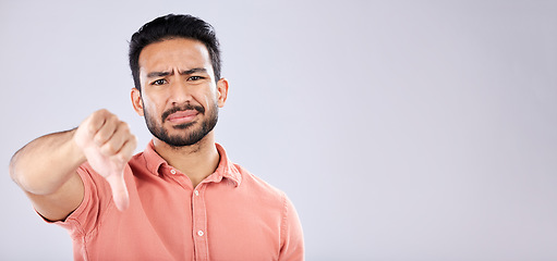 Image showing Fail, thumbs down and portrait of Asian man in studio isolated on a gray background mockup. Dislike hand gesture, emoji and face of sad male model with sign for disagreement, rejection or bad review.