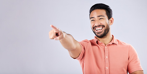 Image showing Happy, laughing and Asian man pointing for bullying isolated on a grey studio background. Funny, joke and Japanese with a hand gesture for making fun, prank and amusement on a backdrop with mockup