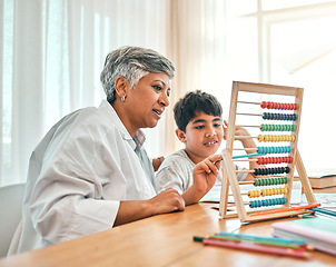 Image showing Education, autism and abacus with a grandmother teaching maths to her grandchild in the home for child development. Family, homework or study and a boy learning with a senior woman tutor in a house