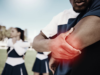 Image showing Cheerleader, sports or hand on elbow injury, pain or accident on field in game or training match. Red glow, fitness zoom or cheerleading male person with a medical emergency, joint or muscle sprain