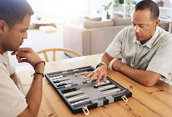 Image showing Man, senior and play backgammon in house with focus, strategy and contest for thinking, moving or son by table. Elderly man, board game competition and relax with bonding, love and family home lounge