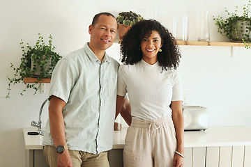 Image showing Happy, love and portrait of a couple in the kitchen of their new modern home together in Mexico. Happiness, smile and mature married man and woman bonding and embracing while standing in their house.