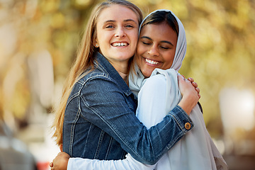 Image showing Portrait, hug and love with a friends in the park together during summer on a blurred background. Happy, smile or diversity with a young female and friend hugging outside in a sunny garden