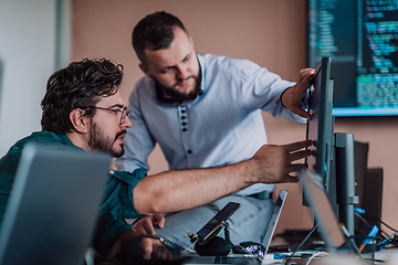 Image showing Programmers engrossed in deep collaboration, diligently working together to solve complex problems and develop innovative mobile applications with seamless functionality.