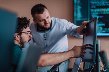 Image showing Programmers engrossed in deep collaboration, diligently working together to solve complex problems and develop innovative mobile applications with seamless functionality.